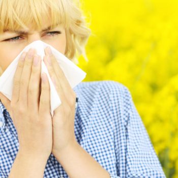 woman sneezing from allergies